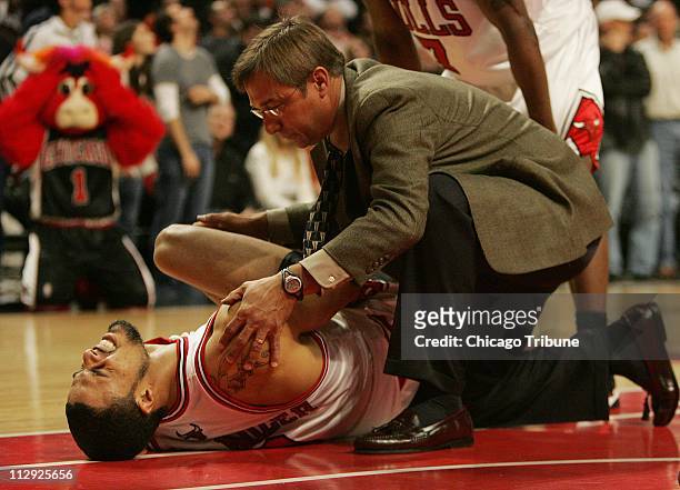 Chicago Bulls Tyson Chandler gets assistance from head athletic trainer Fred Tedeschi in the fourth quarter against the Miami Heat. The Bulls...