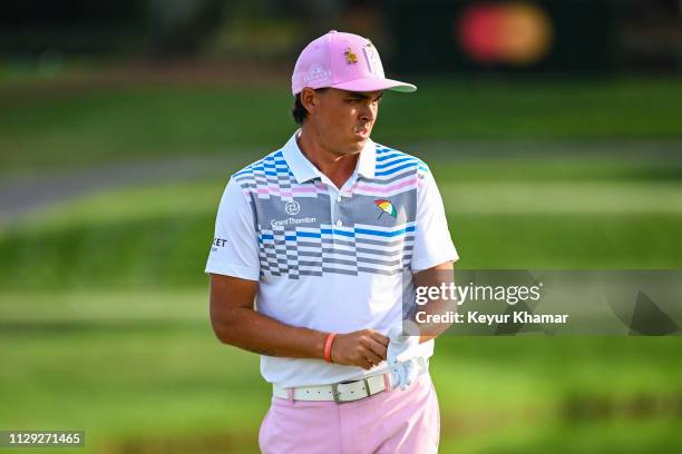 Rickie Fowler puts on his glove on the 17th hole green during the second round of the Arnold Palmer Invitational presented by MasterCard at Bay Hill...
