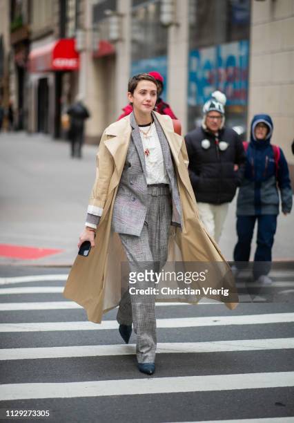 Guest is seen wearing suit, beige trench outside 3.1 Phillip Lim during New York Fashion Week Autumn Winter 2019 on February 11, 2019 in New York...