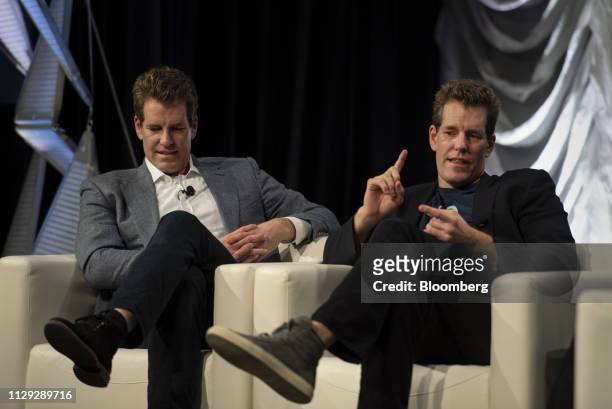 Cameron Winklevoss, president and co-founder of Gemini Trust Co., right, speaks as Tyler Winklevoss, chief executive officer and co-founder of Gemini...