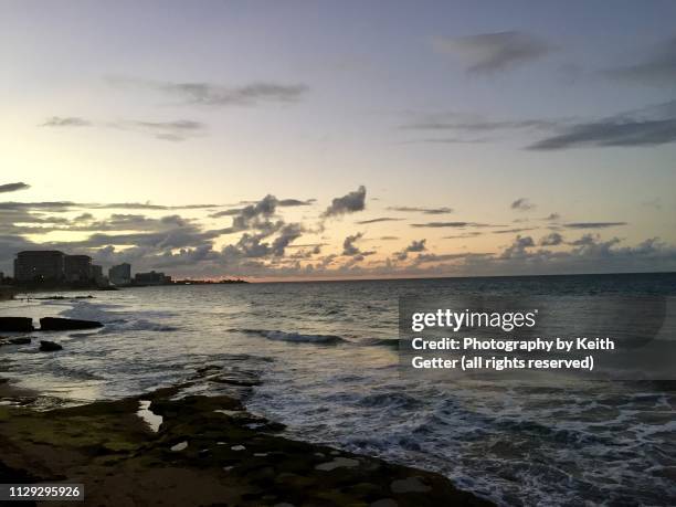 puerto rico beach at sunset after a windy wet winter day - condado beach stock pictures, royalty-free photos & images