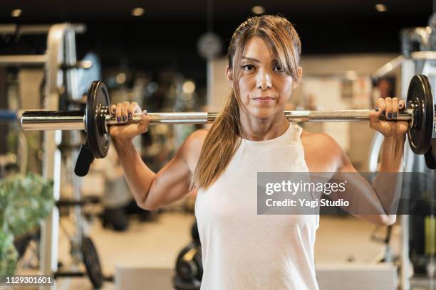 fitness woman working out at private gym - asian female bodybuilder stock pictures, royalty-free photos & images