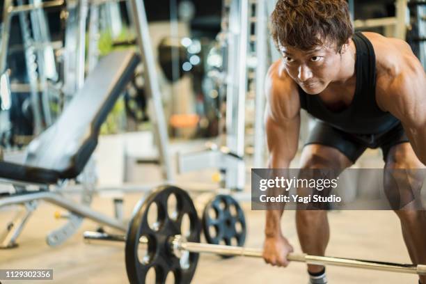 mature adult man working out at personal training gym - japanese ethnicity the human body stock pictures, royalty-free photos & images