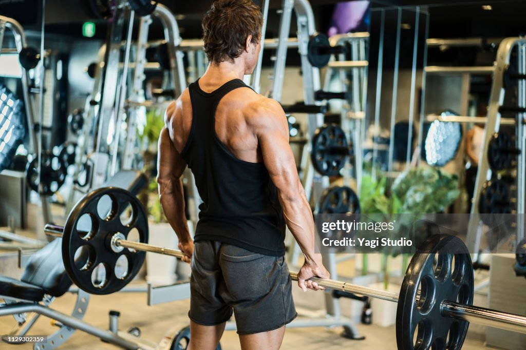 Mature adult man working out at Personal training gym