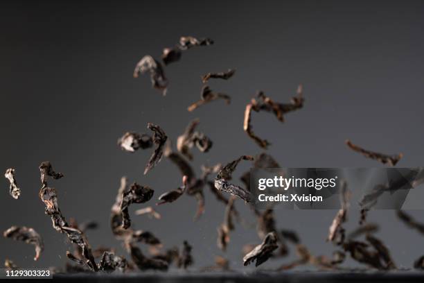 red tea leaves dancing captured with high speed sync"n - powder tea stock pictures, royalty-free photos & images