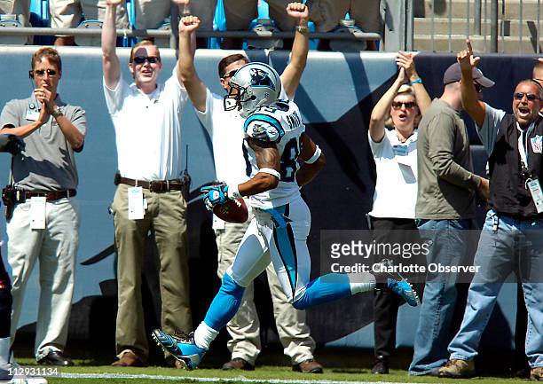 Fans celebrate as Carolina Panthers wide receiver Steve Smith hauls in his first of three touchdowns on the day against the Houston Texans in the...