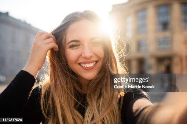 self portrait of playful smiling young woman - model building stock-fotos und bilder