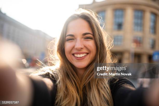 attractive woman posing in front of camera lens - blurred and beautiful stock-fotos und bilder