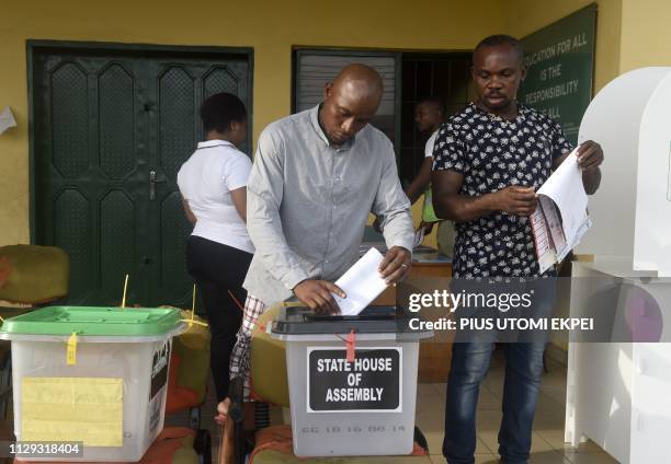 Voters cast their ballots at a polling station in Port Harcourt, Rivers State, on March 9 during voting to elect governors and lawmakers in 29 of the...