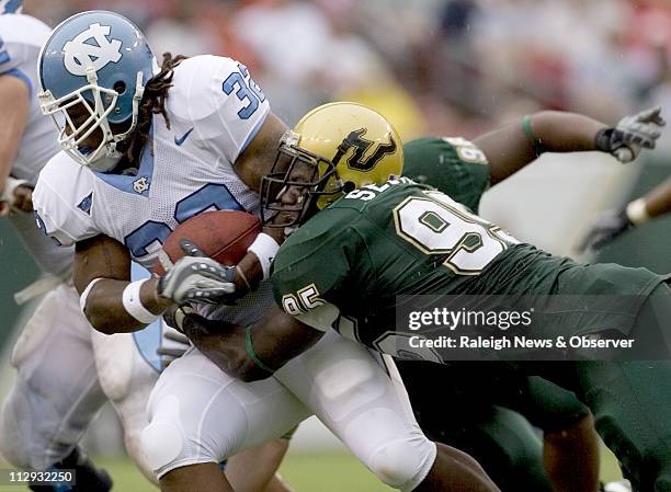 North Carolina tailback Ryan Houston is stopped for a loss of one yard by South Florida's George Selvie during the third quarter on Saturday...