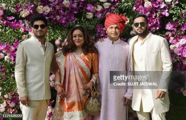 Indian businessman Anil Ambani poses for photographs along with his wife and former Bollywood actress Tina Ambani and their sons, Anshul Ambani and...