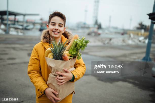 grocery shopping - teenager boy shopping stock pictures, royalty-free photos & images