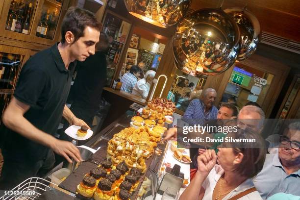 People stand at the bar to order Pinchos at the La Fontana bar on September 29, 2018 in Logrono, Spain. Similar to Tapas, along the Calle Laurel in...
