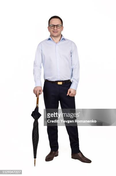 full length portrait of young prosperous businessman dressed in shirt and trousers standing on a white background with closed umbrella - full body isolated bildbanksfoton och bilder