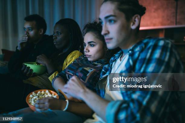 friends watching horror movie - woman watching horror movie stock pictures, royalty-free photos & images