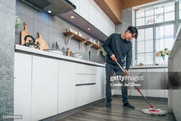 mopping the kitchen floor - kitchen mop stock pictures, royalty-free photos & images