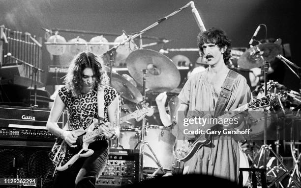 American musicians Steve Vai and Frank Zappa , both on guitar, perform on stage at the Palladium, New York, New York, October 31, 1981.