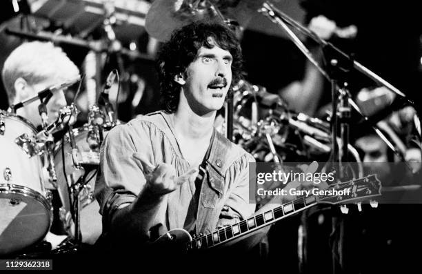 American musician Frank Zappa plays guitar as he performs on stage at the Palladium, New York, New York, October 31, 1981.