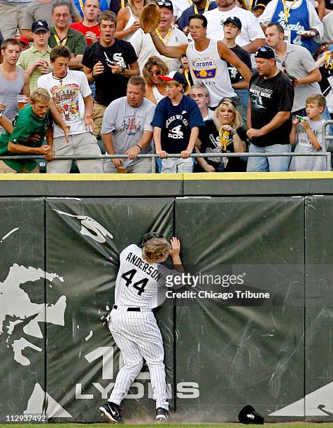 Chicago White Sox's Brian Anderson ends up against the center field wall while chasing Minnesota Twins' Jason Kubel solo home run in the second...