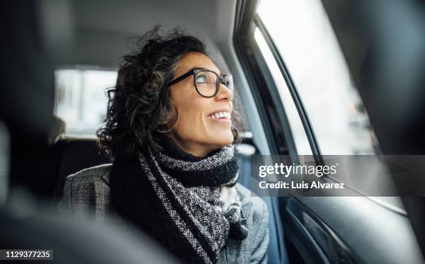 mid adult female traveling by a car - car view stock-fotos und bilder