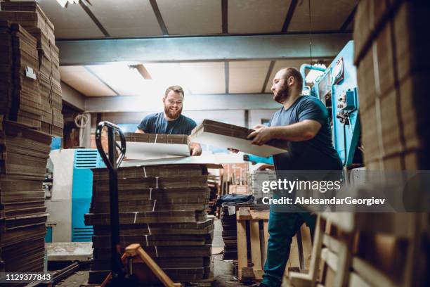 late night cardboard factory shift - physical toughness stock pictures, royalty-free photos & images