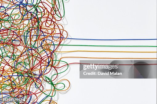 Jumble of multicoloured wires untangling into straight lines over a white background. Jumble of multicoloured wires untangling into straight lines over a white background.