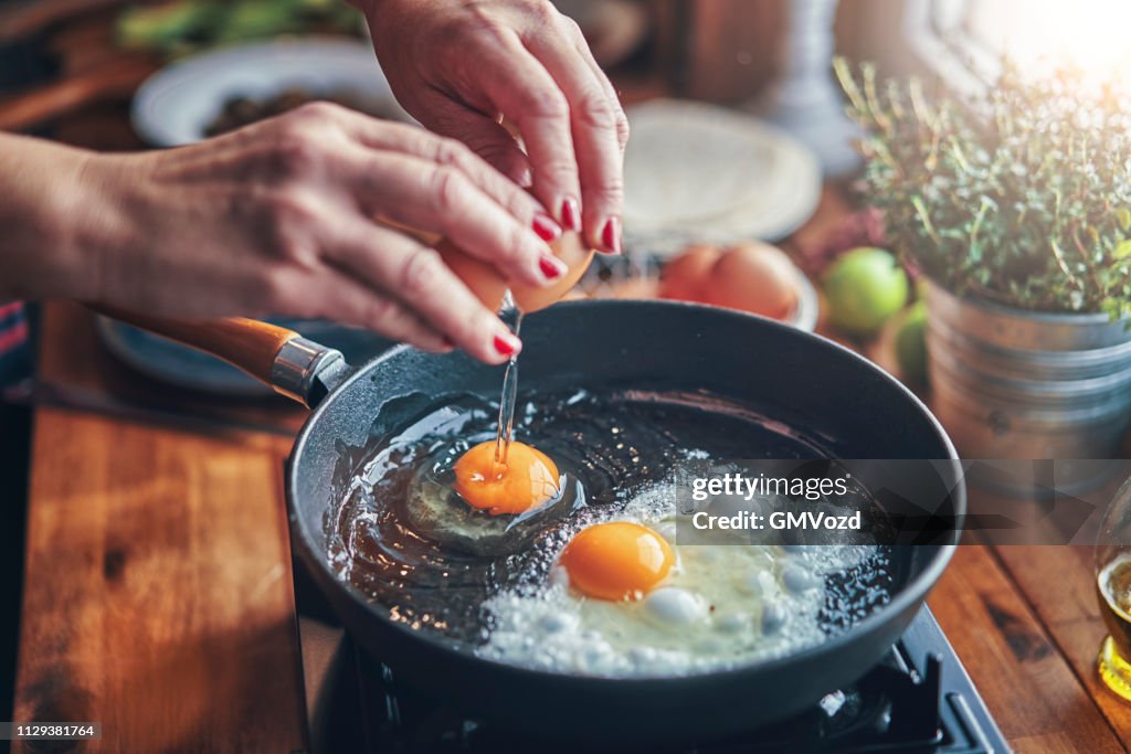 Frying Egg in a Cooking Pan in Domestic Kitchen