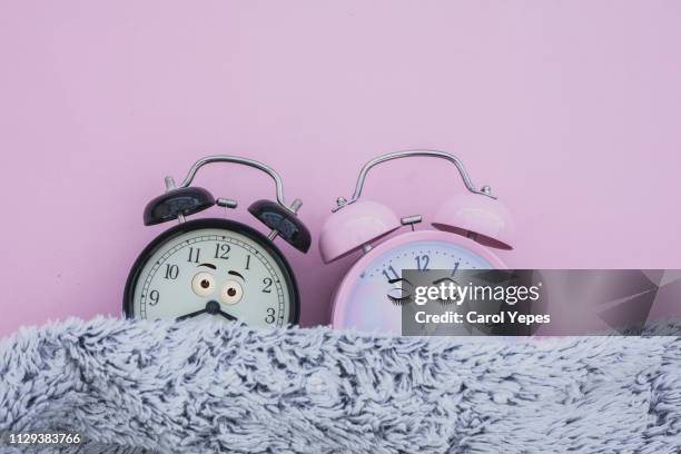 alarm clock female and male sleeping in bed - temi legati alla sessualità foto e immagini stock