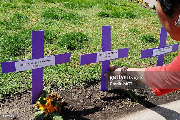 Women place crosses baring the names of victims of "Femicide" -- women killed by partners, husbands, boyfriends, or lovers, September 28, 2007 in...