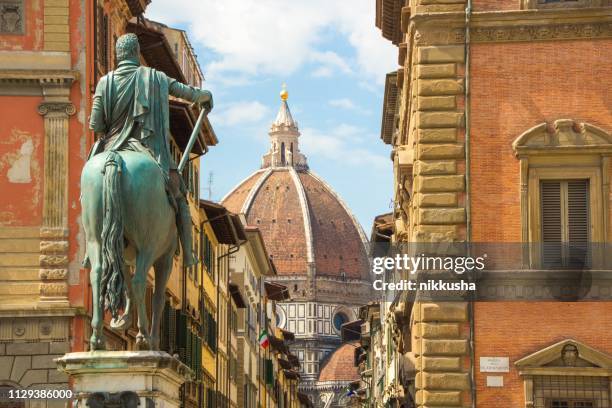 Cathedral of Santa Maria del Fiore and Monument of Cosimo de Medici. View from the Piazza of the Santissima Annunziata. Beautiful sunny day in Florence, Italy.