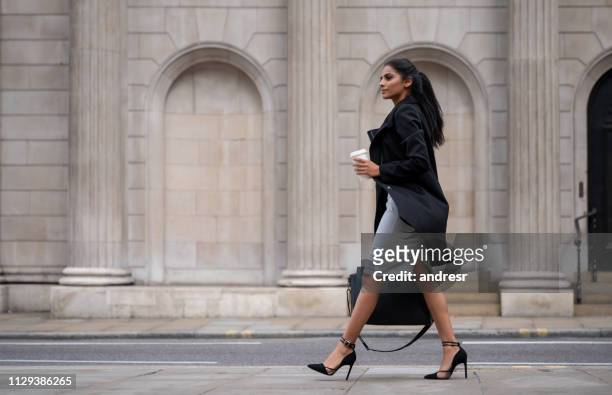 indian business woman walking on the street drinking coffee - business woman walking stock pictures, royalty-free photos & images