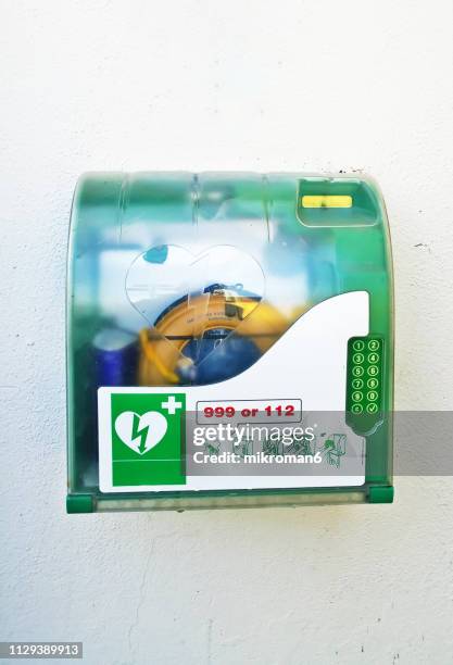 aed automated external defibrillator in public area - defibrillation stock pictures, royalty-free photos & images