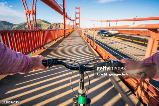 crossing the golden gate bridge by bike - golden gate bridge stock pictures, royalty-free photos & images
