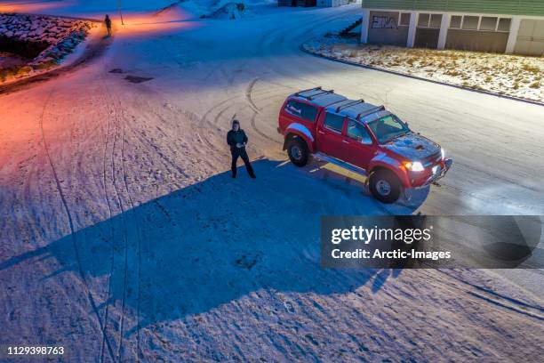 photographer operating a drone by his truck, iceland - old truck in snow stock pictures, royalty-free photos & images