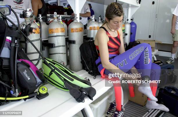 Frenchwoman Audrey Mestre Ferreras adjusts a diving watch to her ankle as she prepares to join her husband Pipin Ferreras to set the first record in...