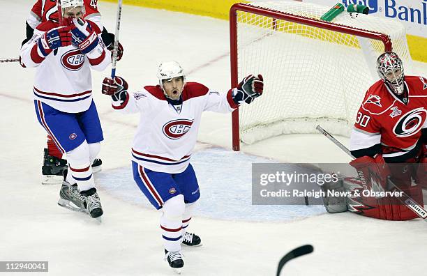 Carolina Hurricanes goalie Cam Ward watches the Montreal Canadiens' Tomas Plekanec celebrate his team's first period goal. The Canadiens defeated the...