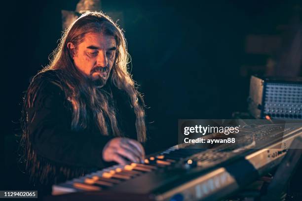 rock musician playing keyboard on stage - rock n roll vintage stock pictures, royalty-free photos & images