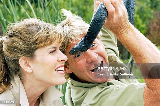 The Crocodile Hunter", Steve Irwin, shows a snake to his wife Terri at the San Francisco Zoo on June 26, 2002 in San Francisco, California. Irwin is...