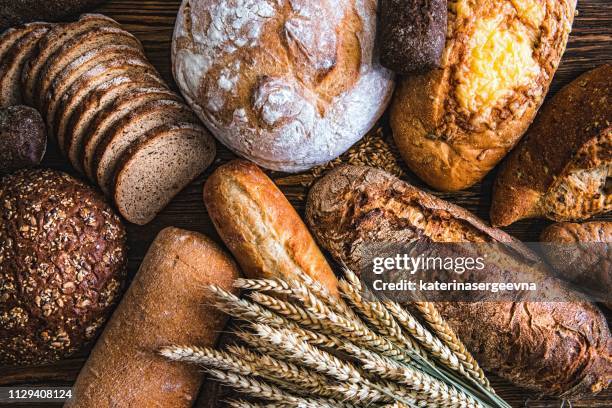 still life with breads and wheats - cake shop stock pictures, royalty-free photos & images