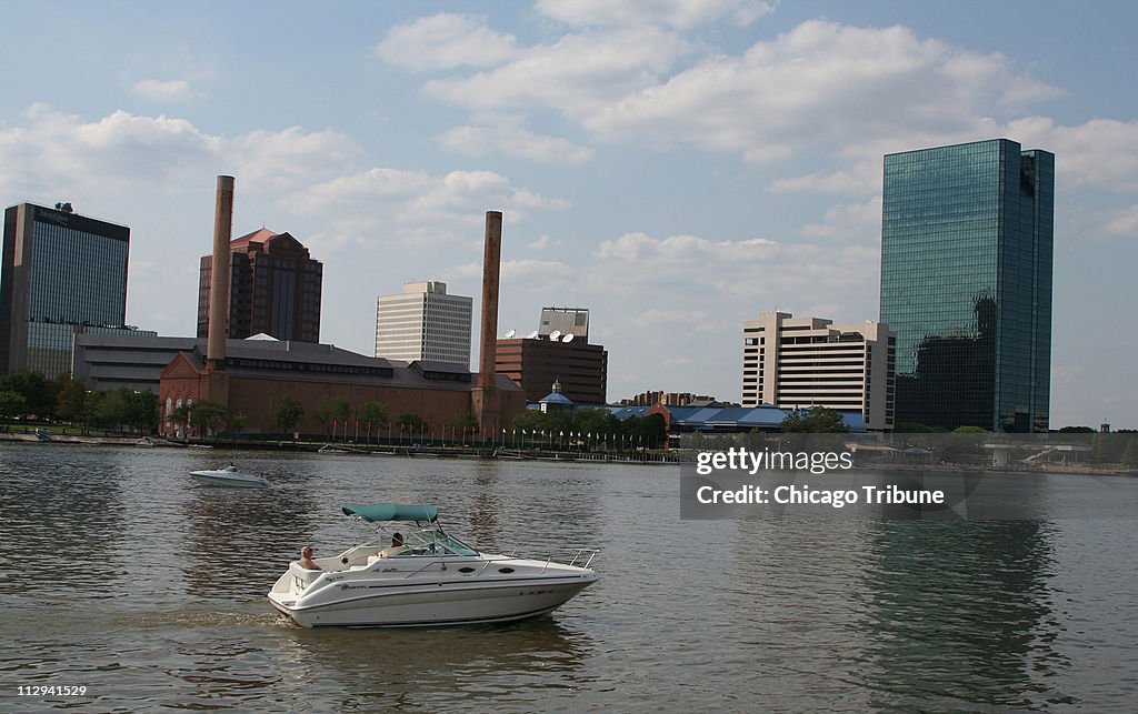 A pleasure boat sails the Maumee River past downtown Toledo,