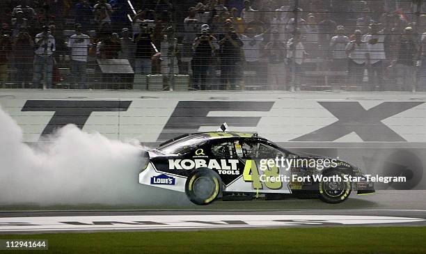 Jimmie Johnson celebrates winning the NASCAR Nextel Cup series Dickies 500 race at Texas Motor Speedway in Fort Worth, Texas, Sunday, November 4,...