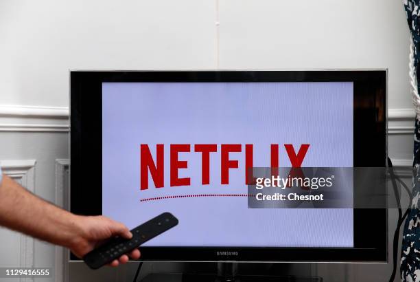 In this photo illustration, the Netflix media service provider's logo is displayed on the screen of a television on February 13, 2019 in Paris,...