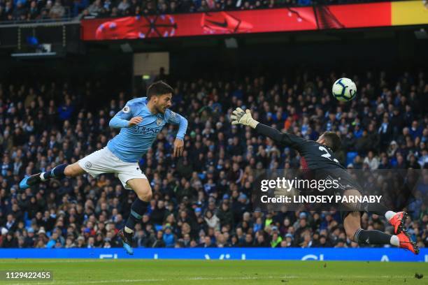 Manchester City's Spanish midfielder David Silva tests Watford's English goalkeeper Ben Foster during the English Premier League football match...