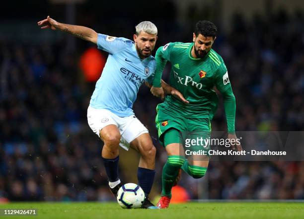 Sergio Aguero of Manchester City and Miguel Britos of Watford FC in action during the Premier League match between Manchester City and Watford FC at...