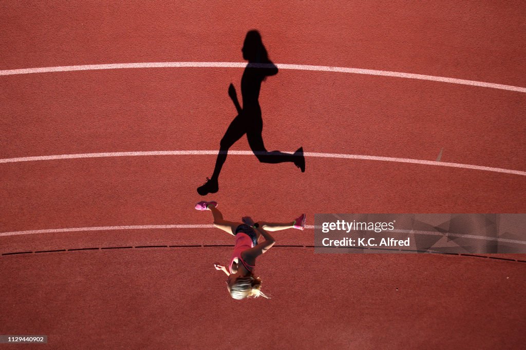 A female athlete runs on a track