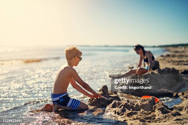 kids playing on the beach - baltic sea stock pictures, royalty-free photos & images