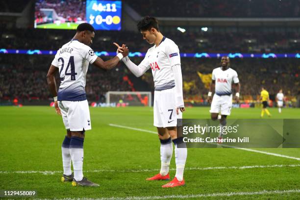 Son Heung-Min of Tottenham celebrates scoring to make it 1-0 with team mate Serge Aurier during the UEFA Champions League Round of 16 First Leg match...
