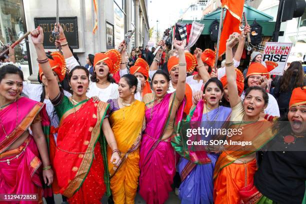 Women in colourful Indian outfits are seen shouting during the Million Women Rise March in London. Thousands of women are seen taking part in the...