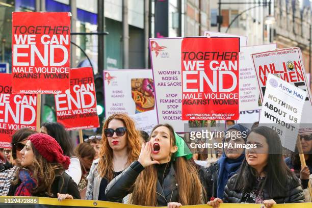 Women are seen shouting slogans during the Million Women Rise March in London. Thousands of women are seen taking part in the 11th anniversary of...