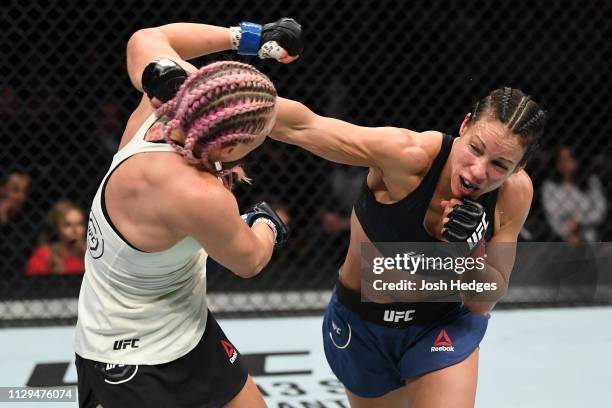 Marion Reneau punches Yana Kunitskaya of Russia in their women's bantamweight bout during the UFC Fight Night event at Intrust Bank Arena on March 9,...